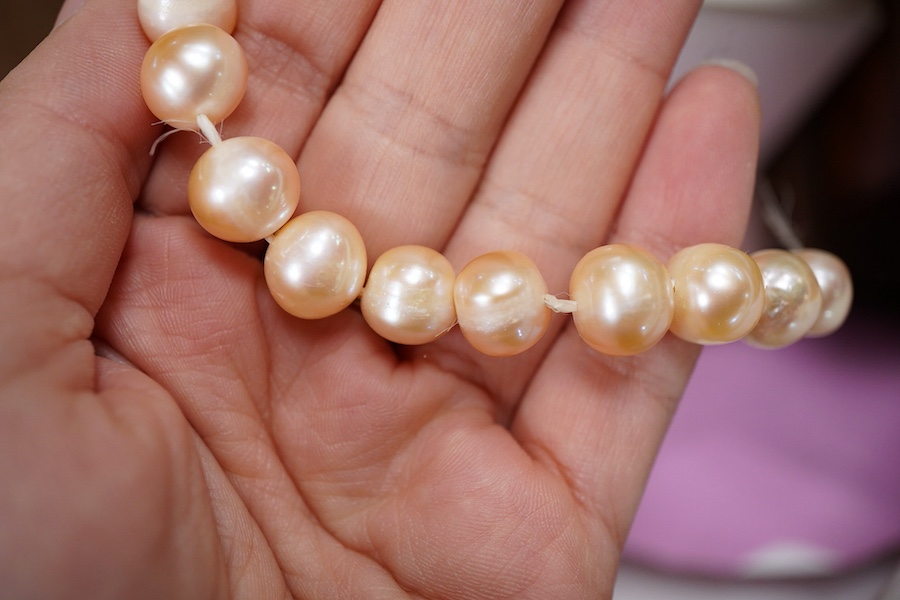 A cultured pearl necklace, composed of graduated cultured pearls of pale pink tint measuring approximately 11-12mm, to a spherical clasp stamped 14K; a black opal measuring approximatley 11 x 7mm, on a display cushion; a